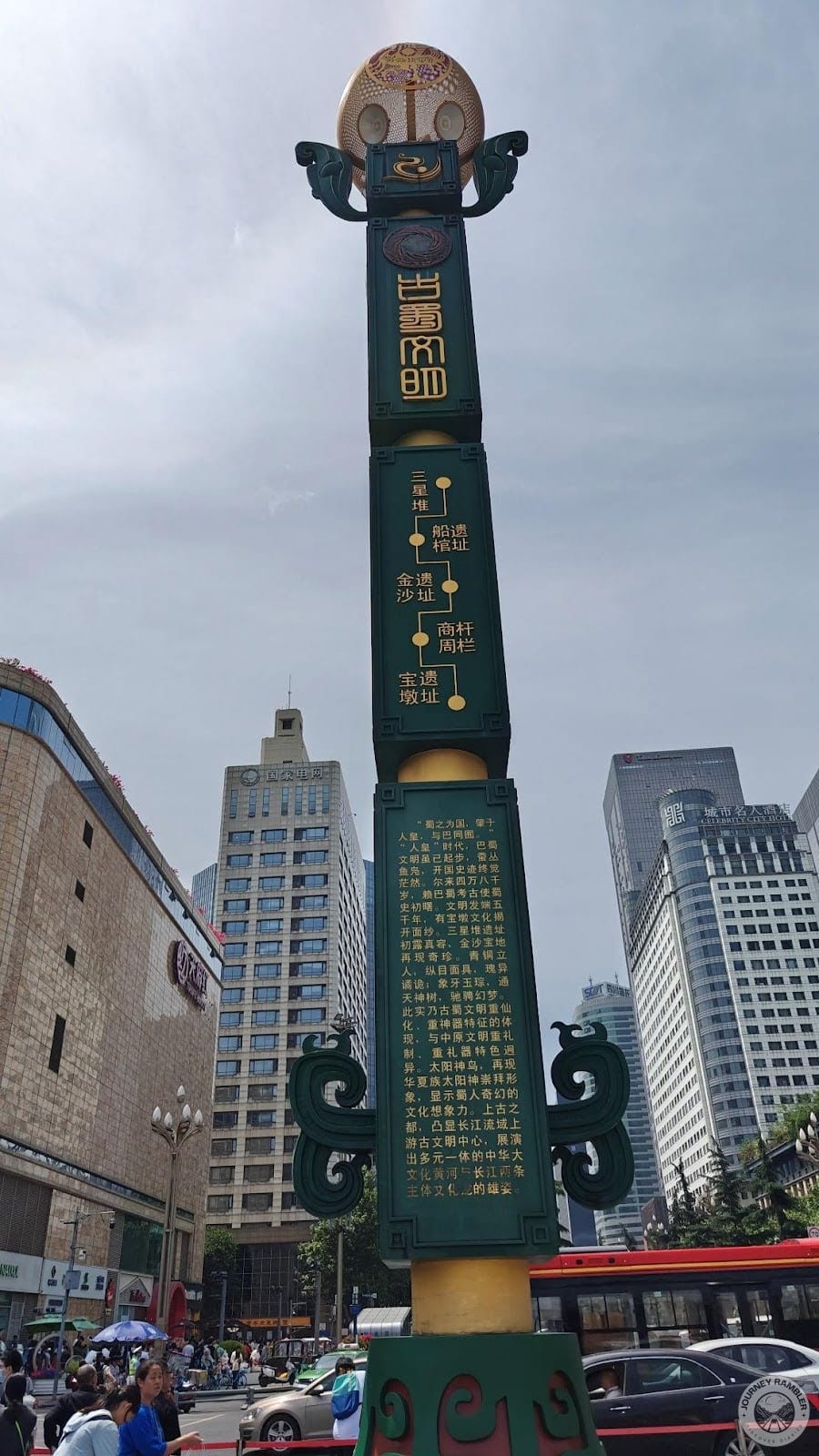 very tall pillar in one corner of the square