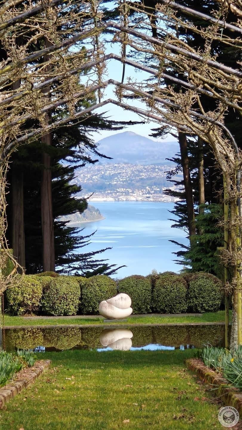 view of the stone sculpture with Otago Harbour in the background
