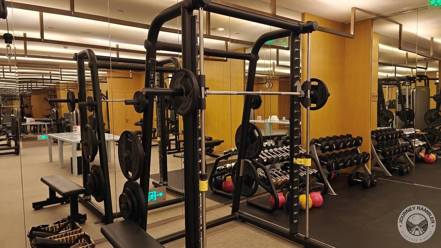 weight training station filled with barbells and dumbbells
