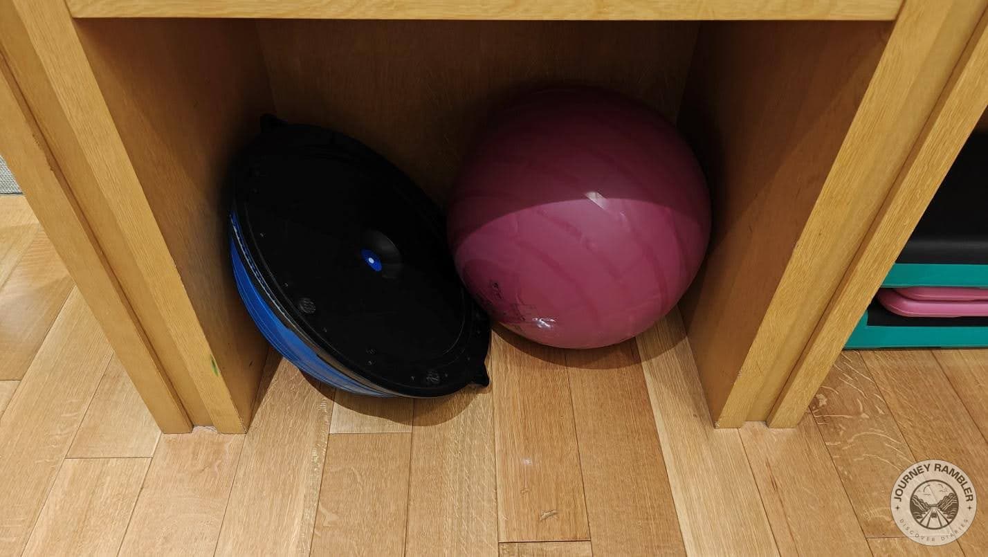 wooden shelves filled with balls, gloves and some hand games