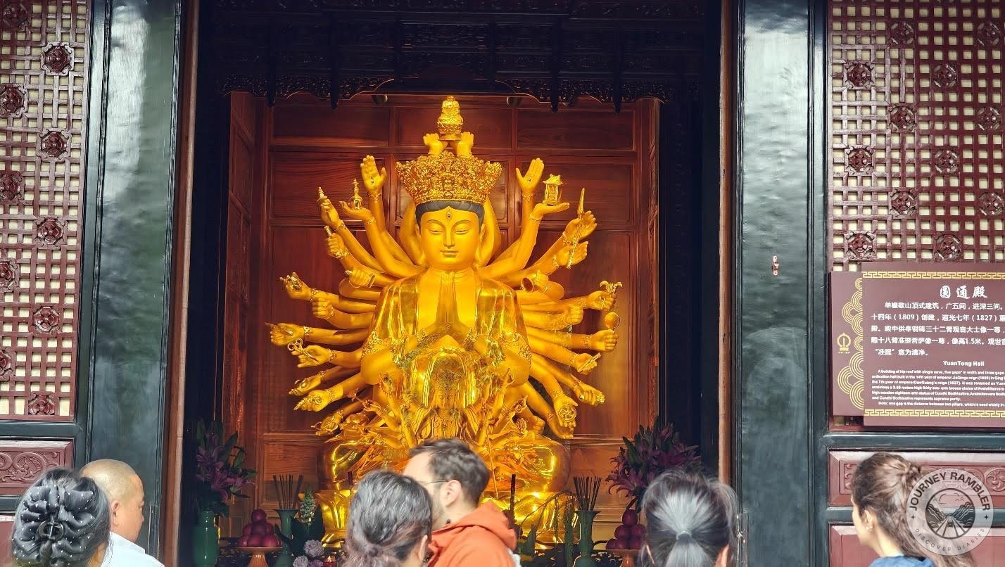 Guanyin is depicted in a multi-armed form
