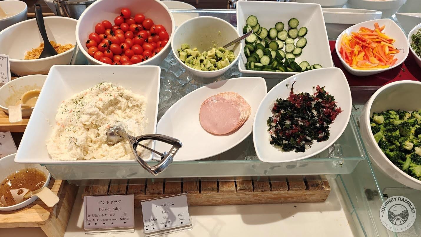 cucumbers, cherry tomatoes, potato salad and thin slices of ham