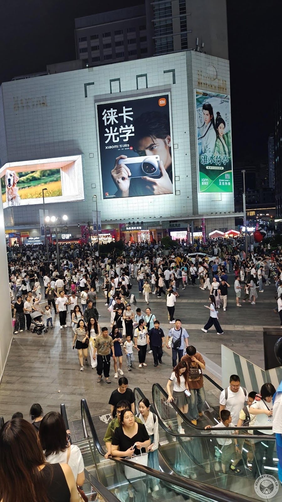 hundreds of people gathered on the street below