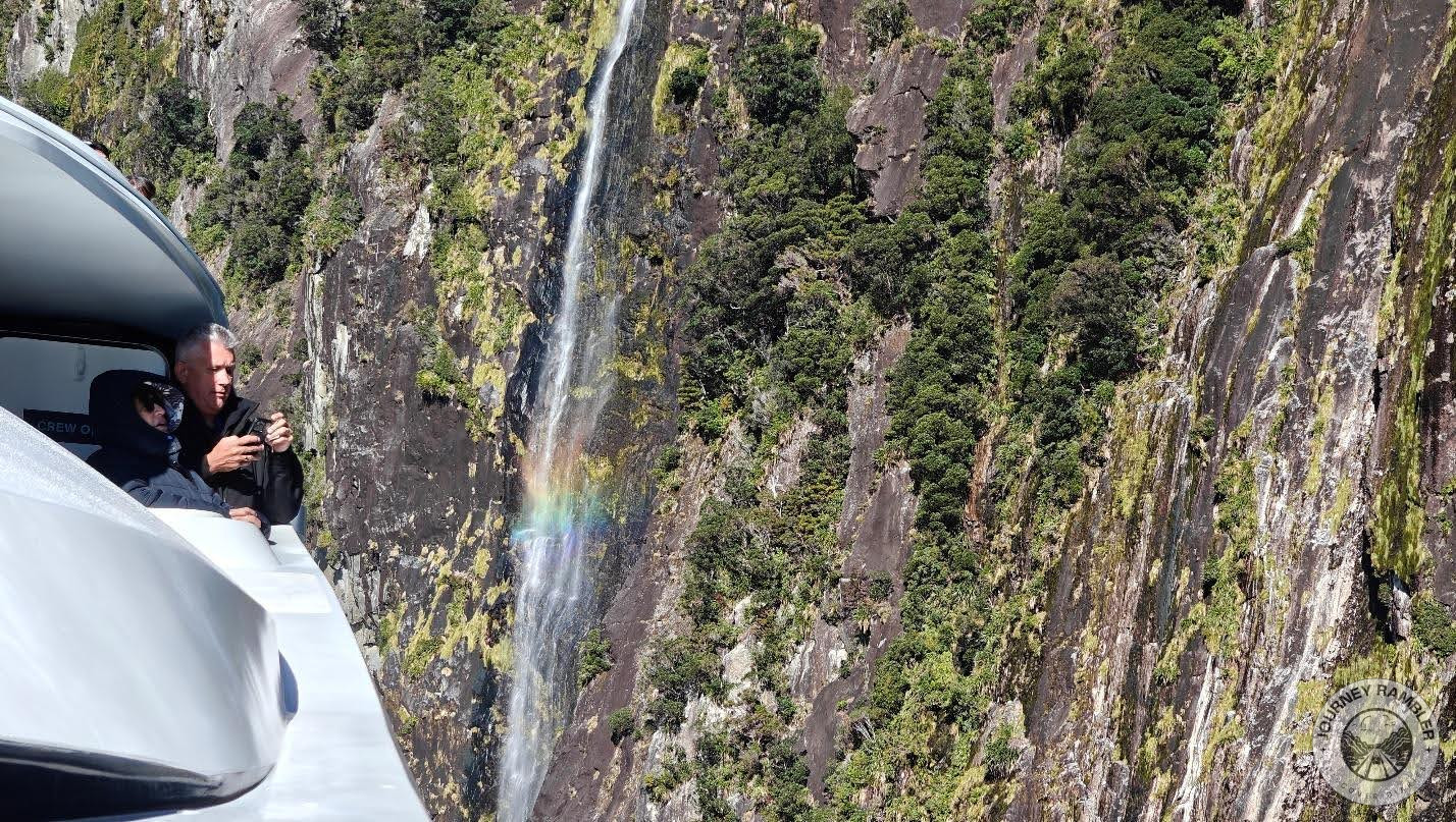 man taking pictures of Stirling Falls