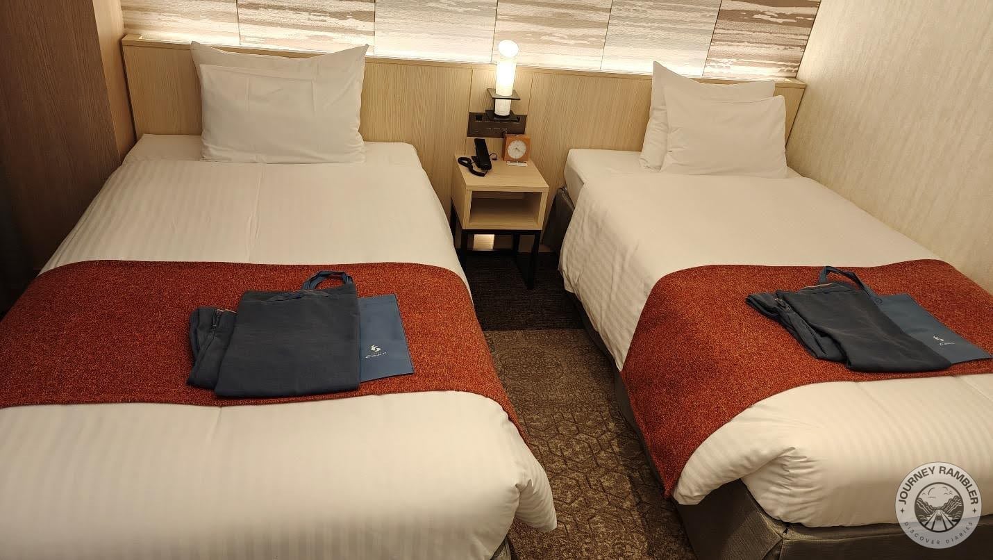 nightstand in between the two beds