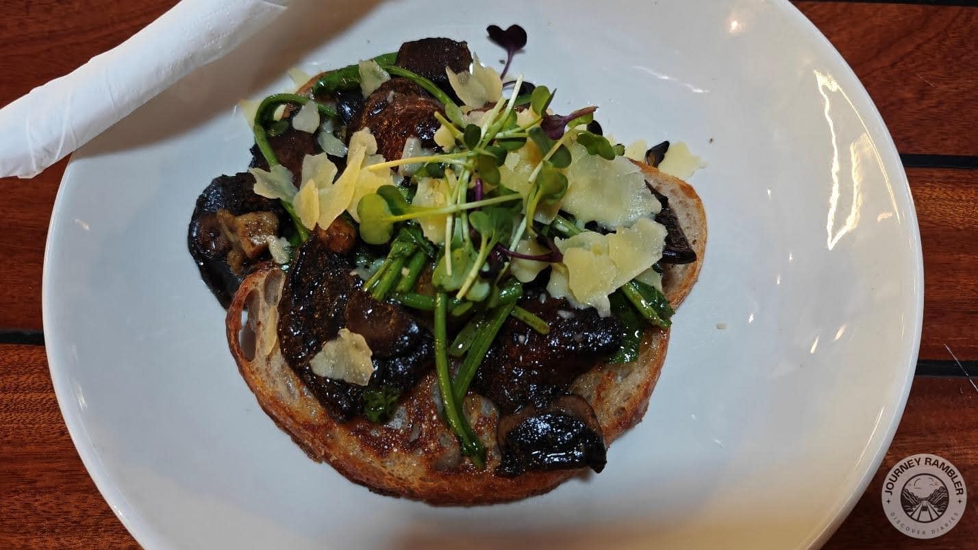 some mushrooms on toast and it was topped with cheese