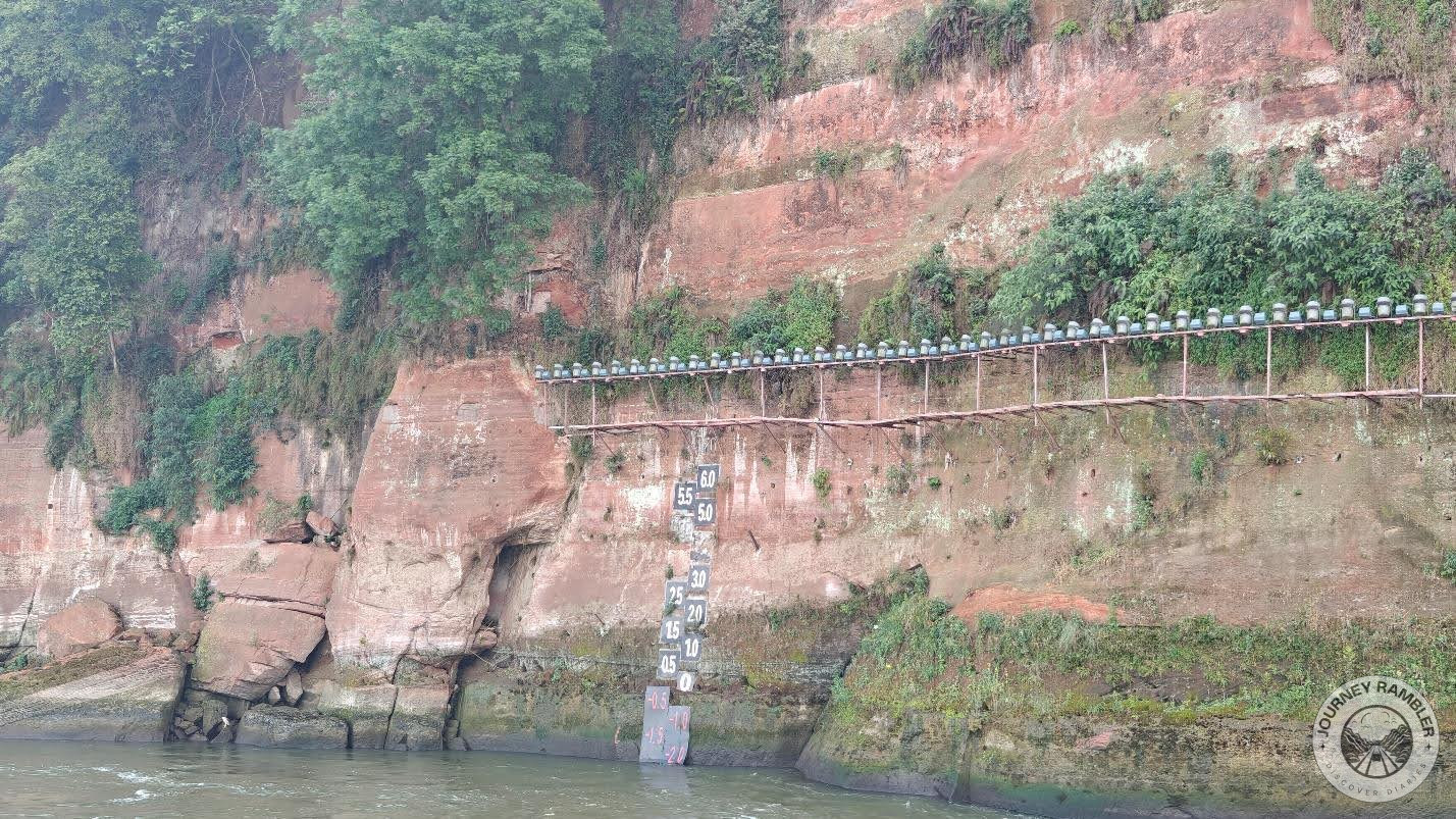 staff gauge measuring the level of water in the river