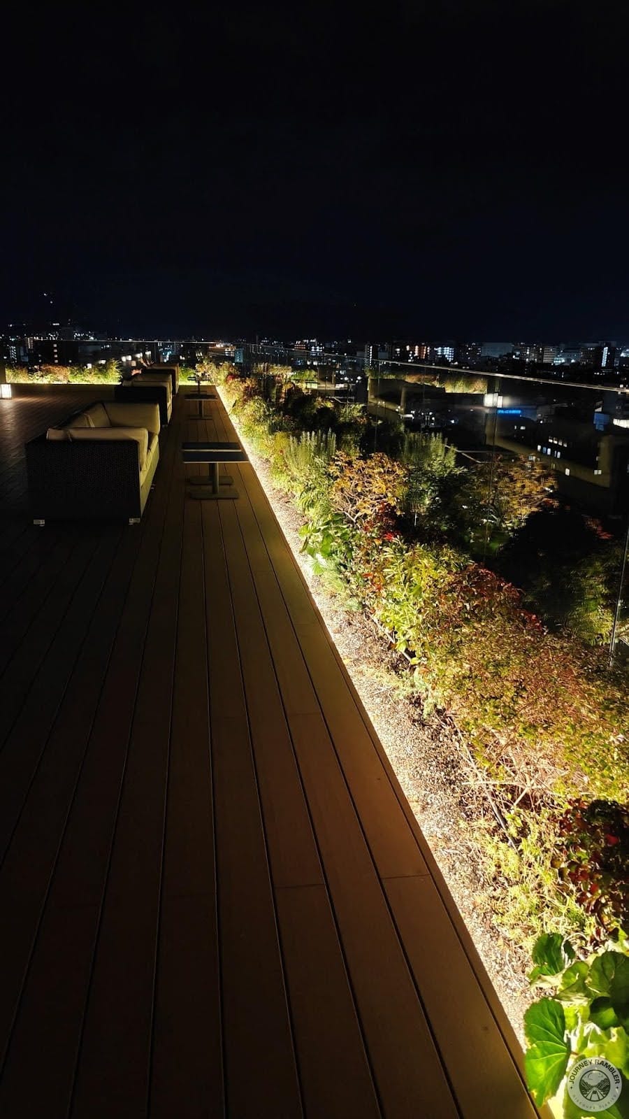 terrace had a wooden deck and plants were growing along the edges