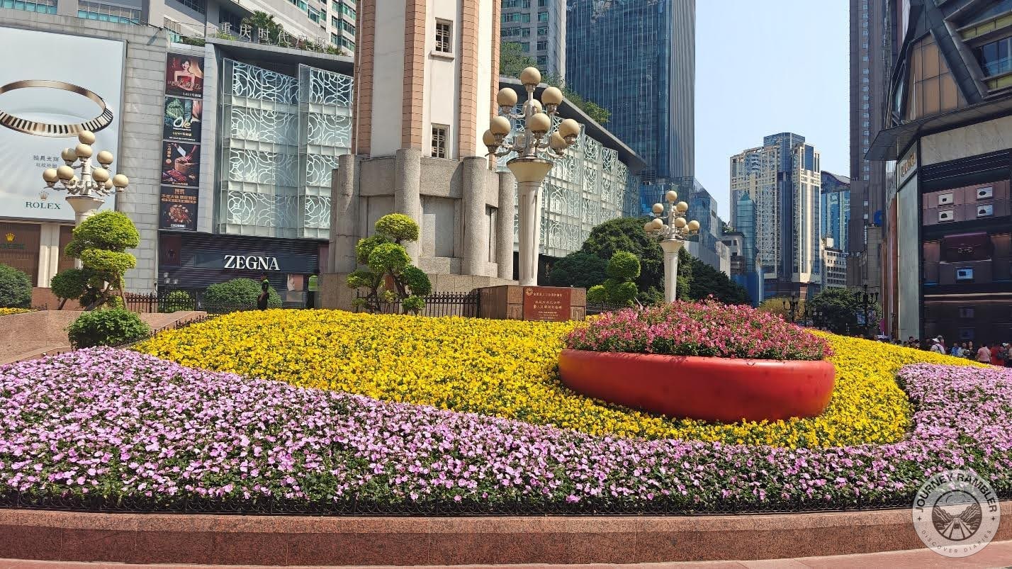 yellow and pink flowers growing at the base of the monument