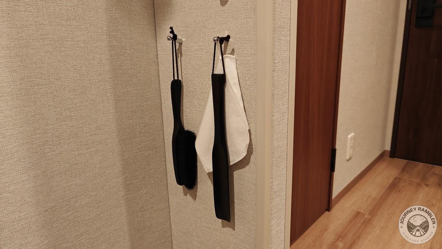 Hooks lined the little corridor outside the bathroom