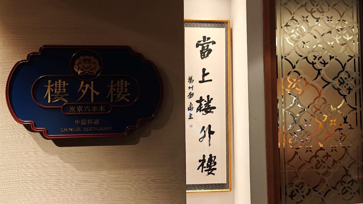 Blue sign and calligraphy in Chinese restaurant entrance.