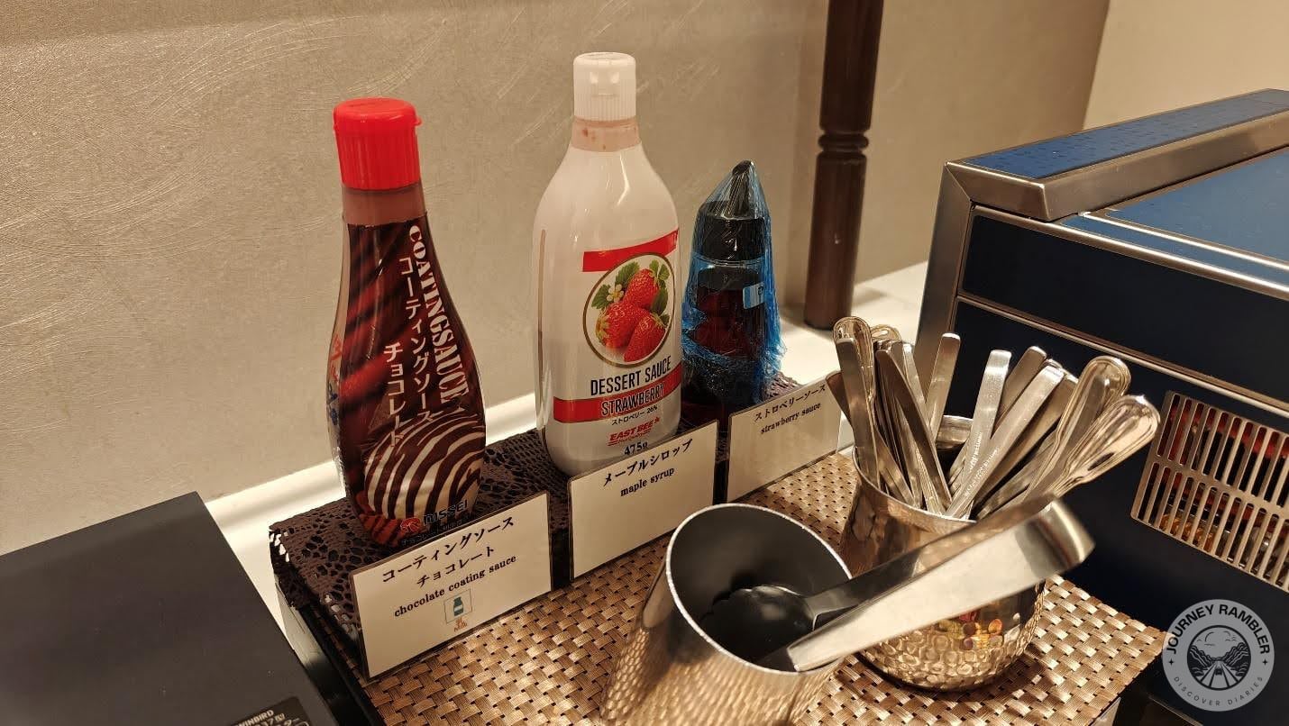 bottles of chocolate and strawberry sauce and maple syrup
