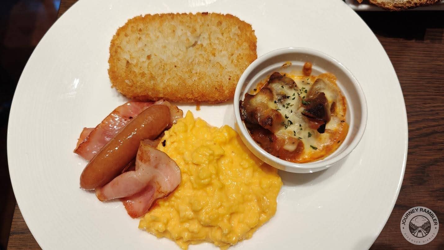 scrambled eggs, sausage, bacon, hash browns and ratatouille gratin