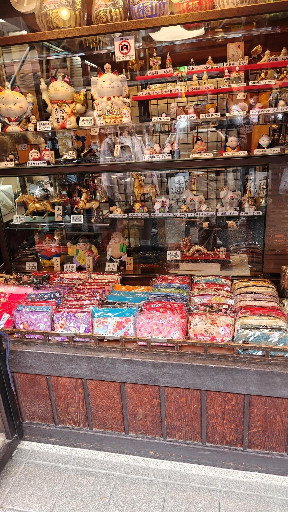 Colorful figurines and textiles displayed at a shopfront