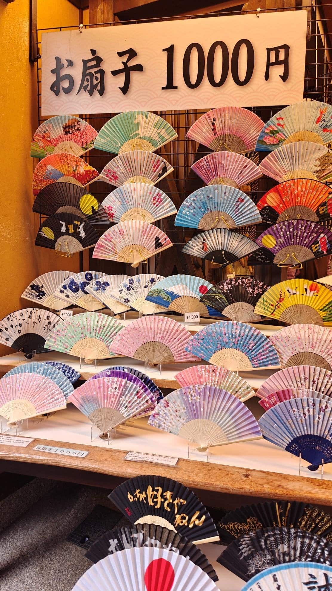 Colorful folding fans displayed for sale in a market stall