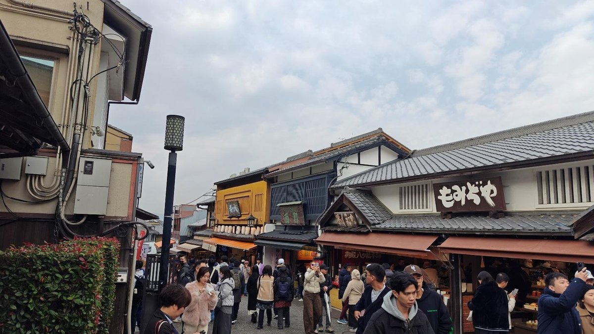 Crowded street market with traditional buildings