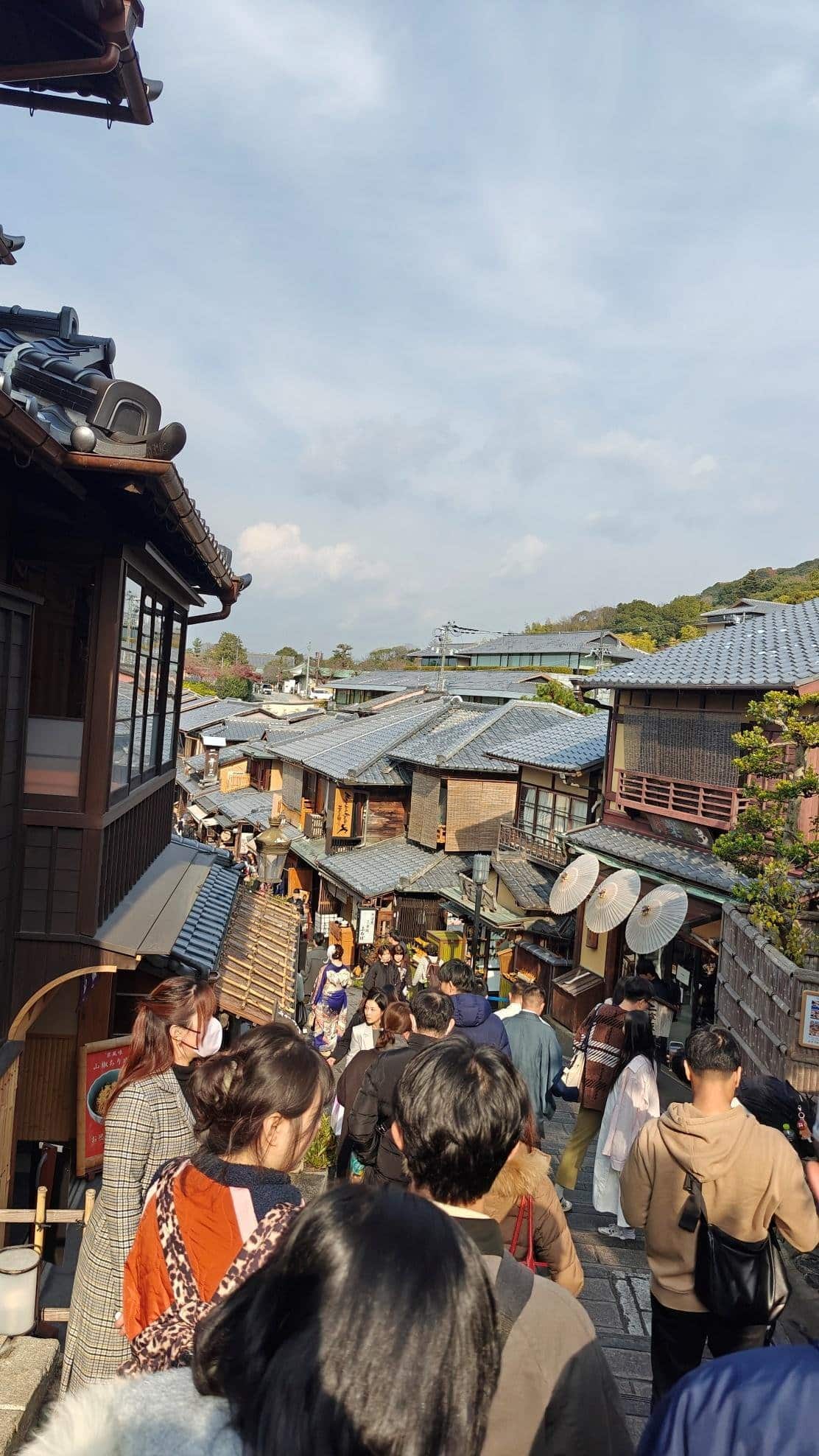 Crowded street with traditional buildings and people walking