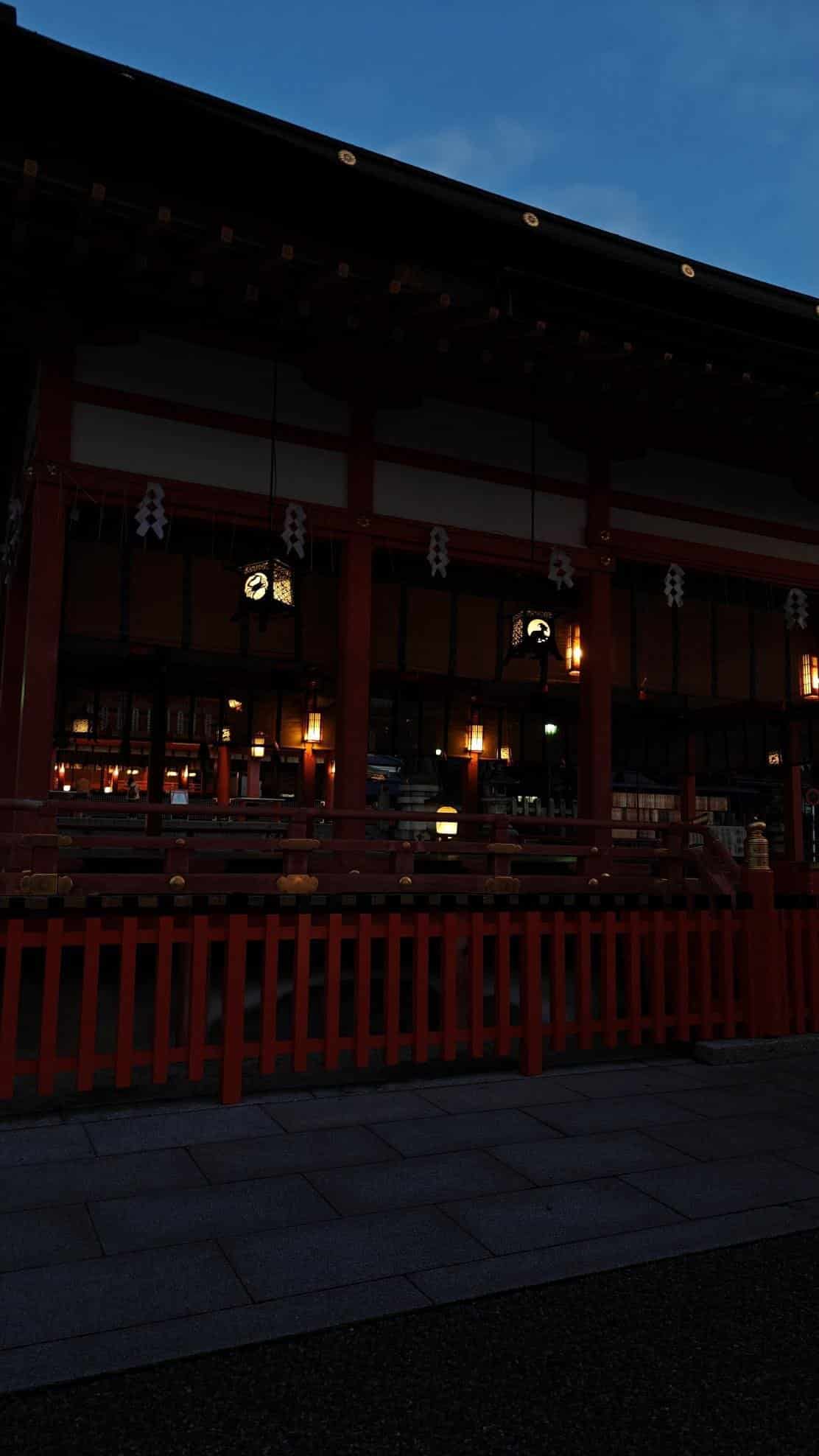 Dimly lit traditional building with red accents and lanterns