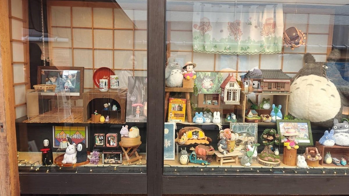 Display of Totoro and anime-themed collectibles in window