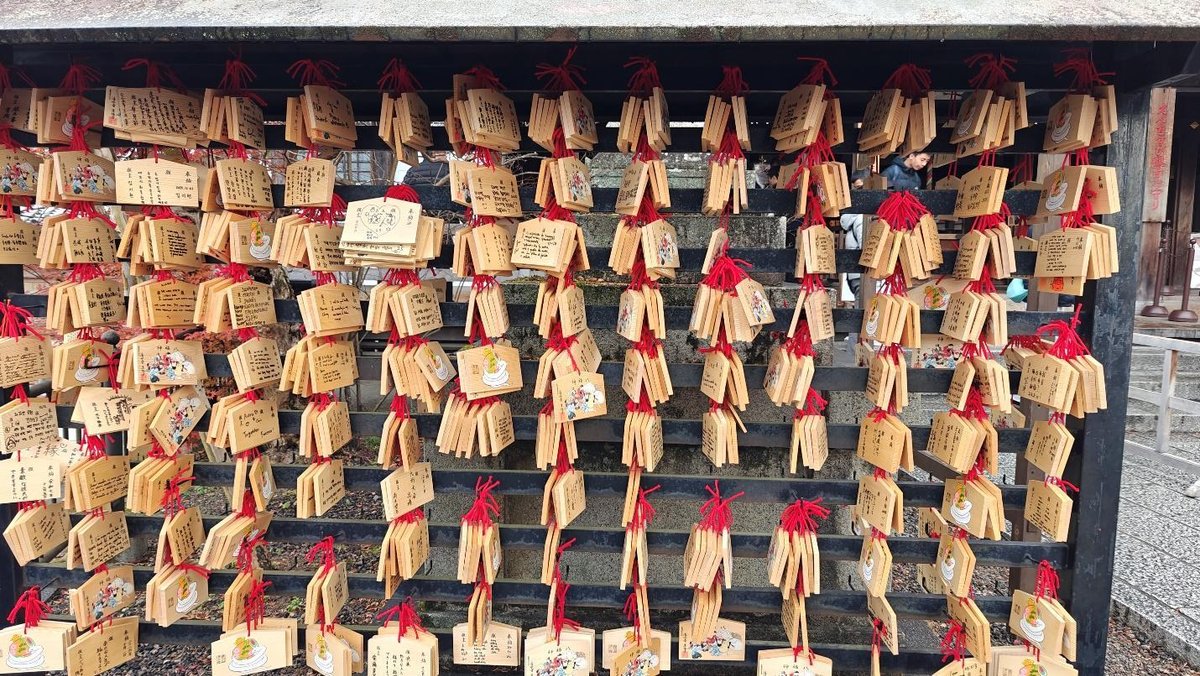Ema plaques hanging with red tassels at a Japanese shrine