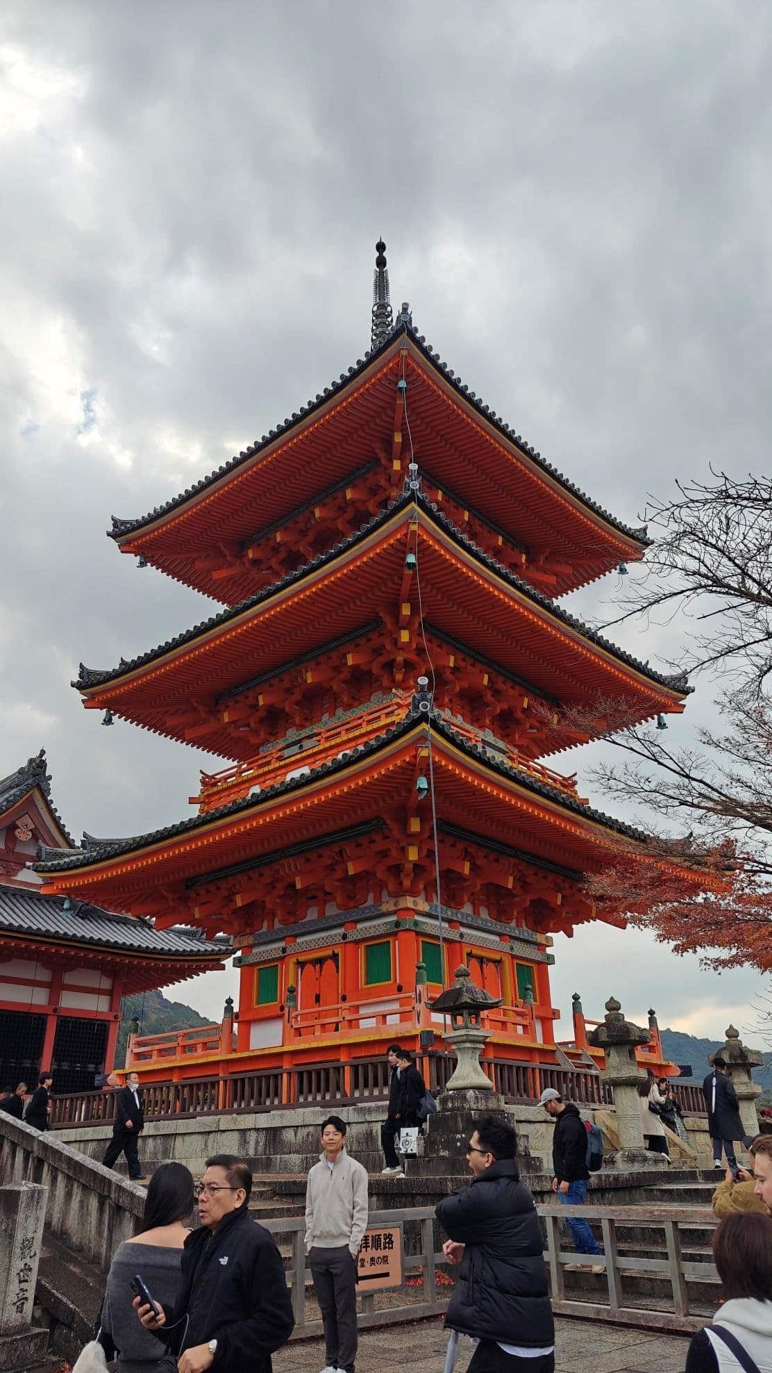Pagoda with tourists under cloudy sky