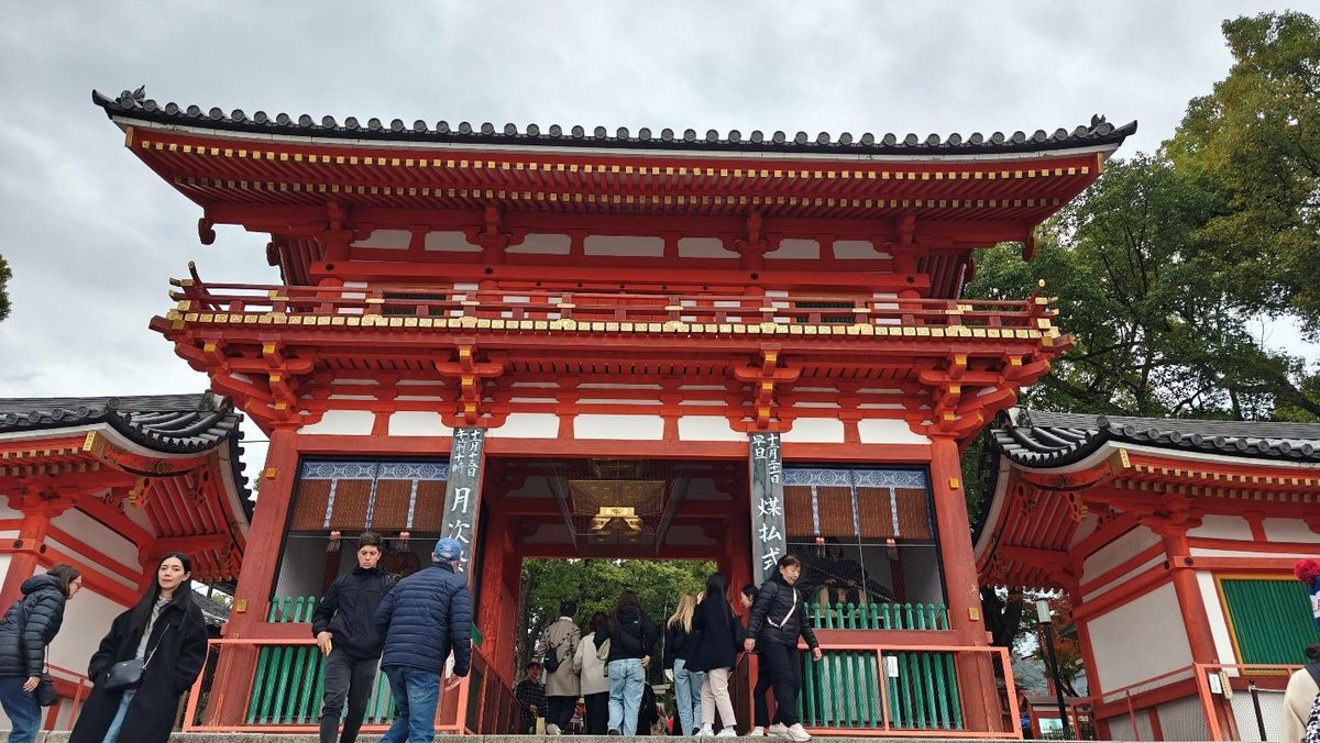 People visiting a traditional red Japanese temple gate