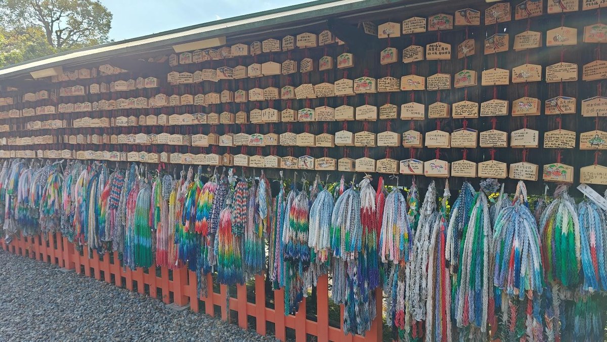 Prayer plaques and colorful origami cranes at a shrine