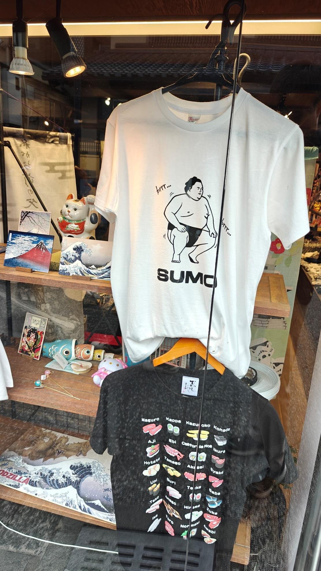 Shop window with sumo and sushi-themed t-shirts