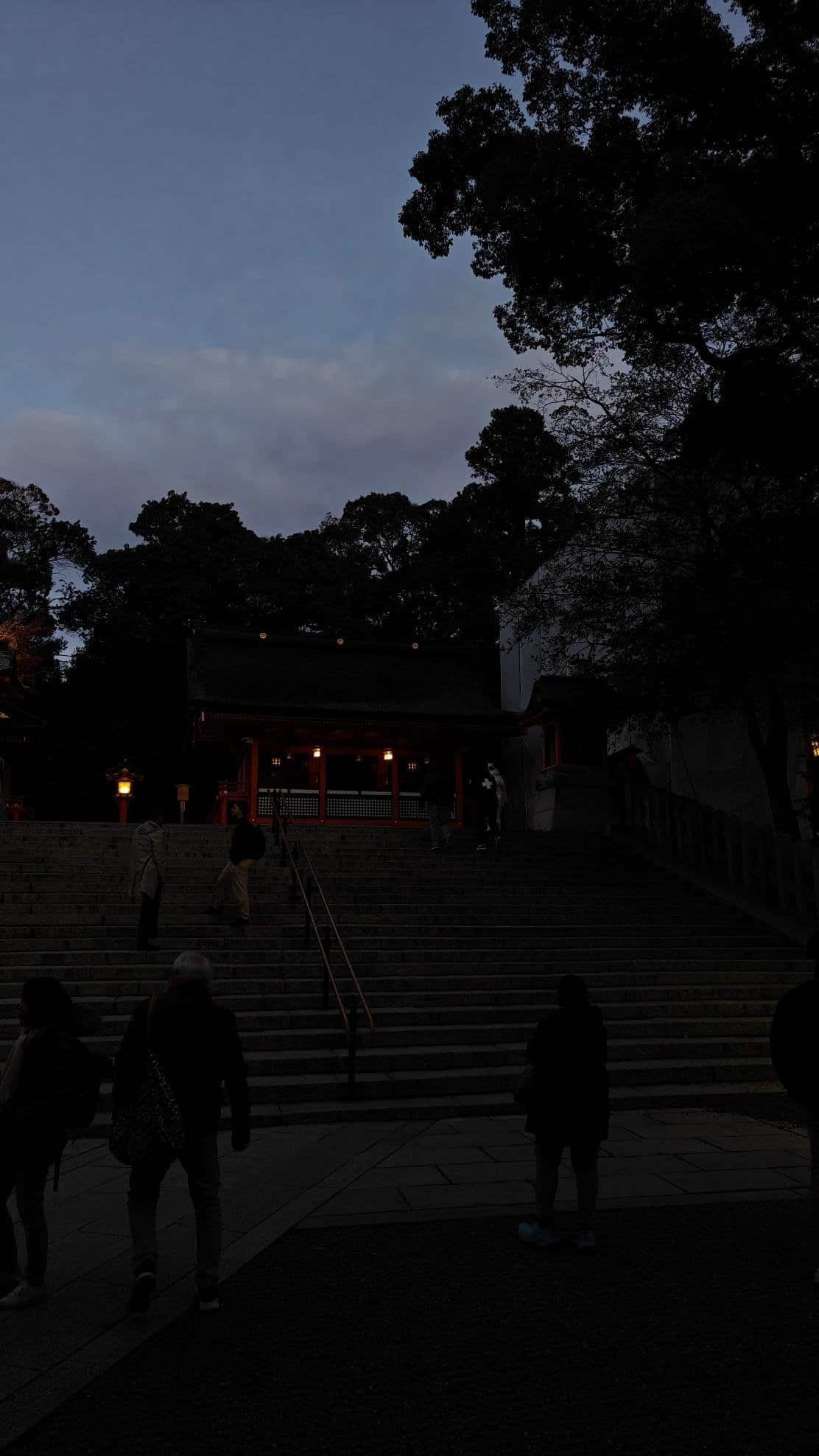 Silhouette of people at temple steps during dusk