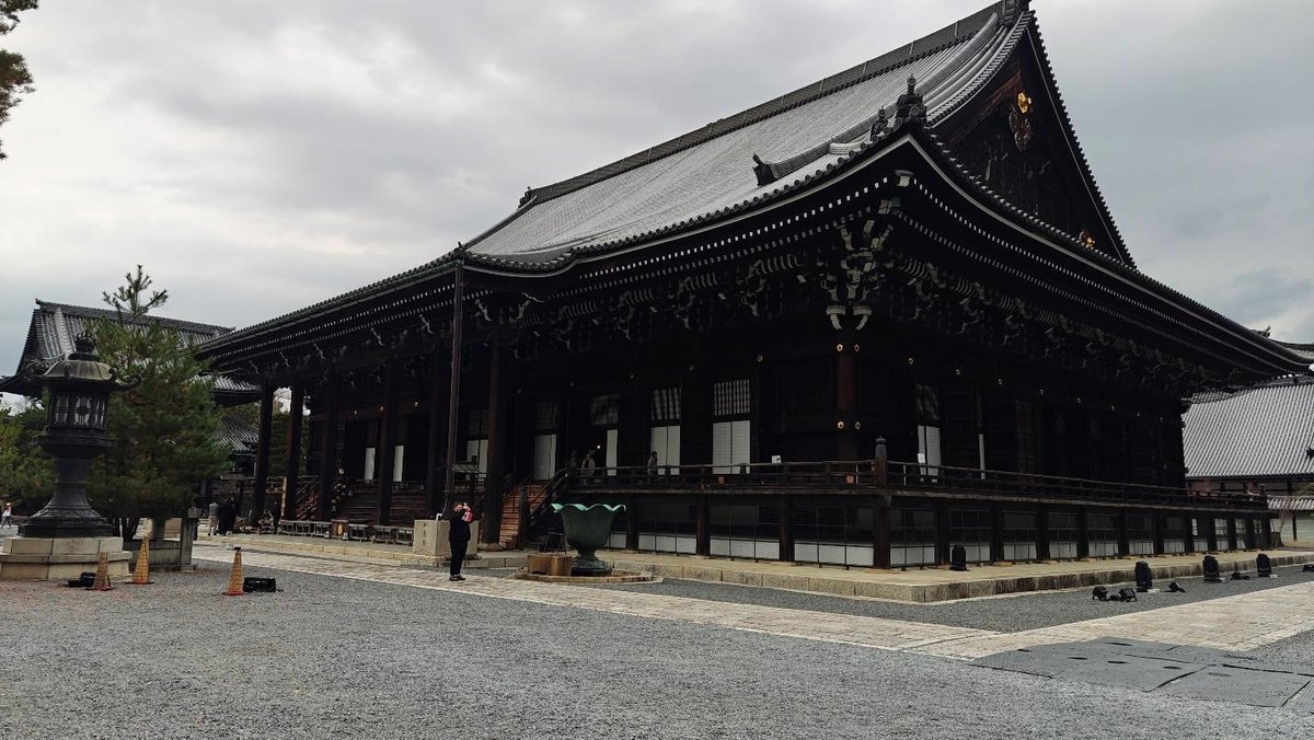 Traditional Japanese temple with ornate roof in cloudy weather