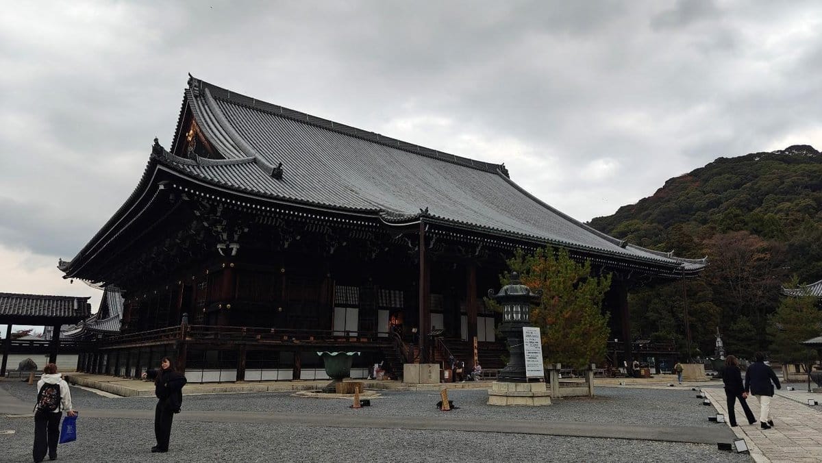 Traditional Japanese temple with ornate roof in overcast weather