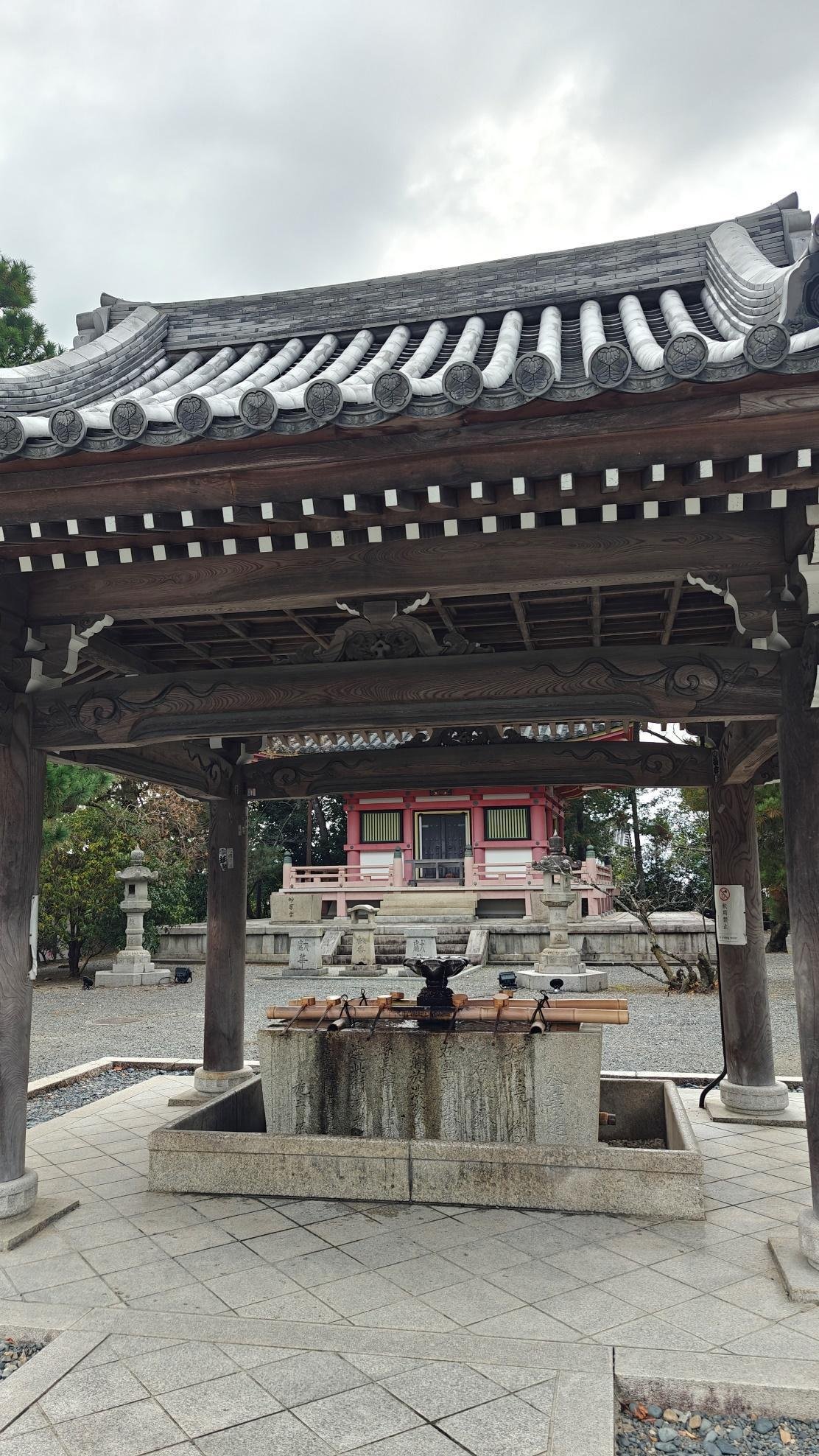 Traditional Japanese temple with wooden structure and stone washbasin