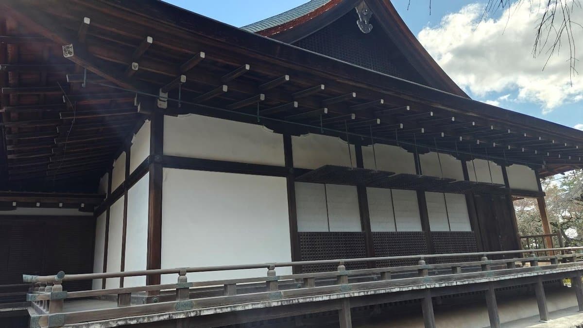 Traditional Japanese wooden building under a cloudy sky