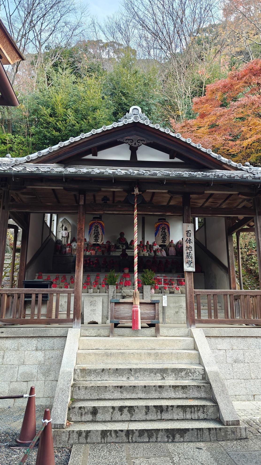 Traditional shrine with stone lanterns and autumn foliage