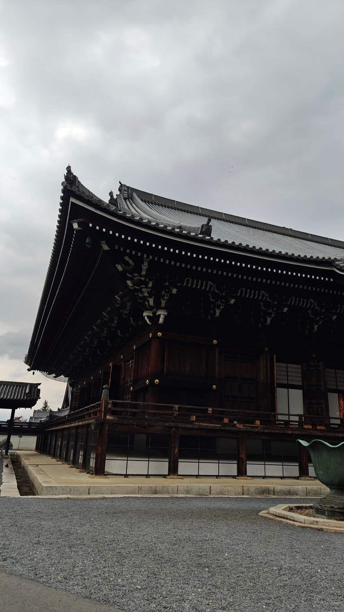 Traditional temple with ornate roof under cloudy sky