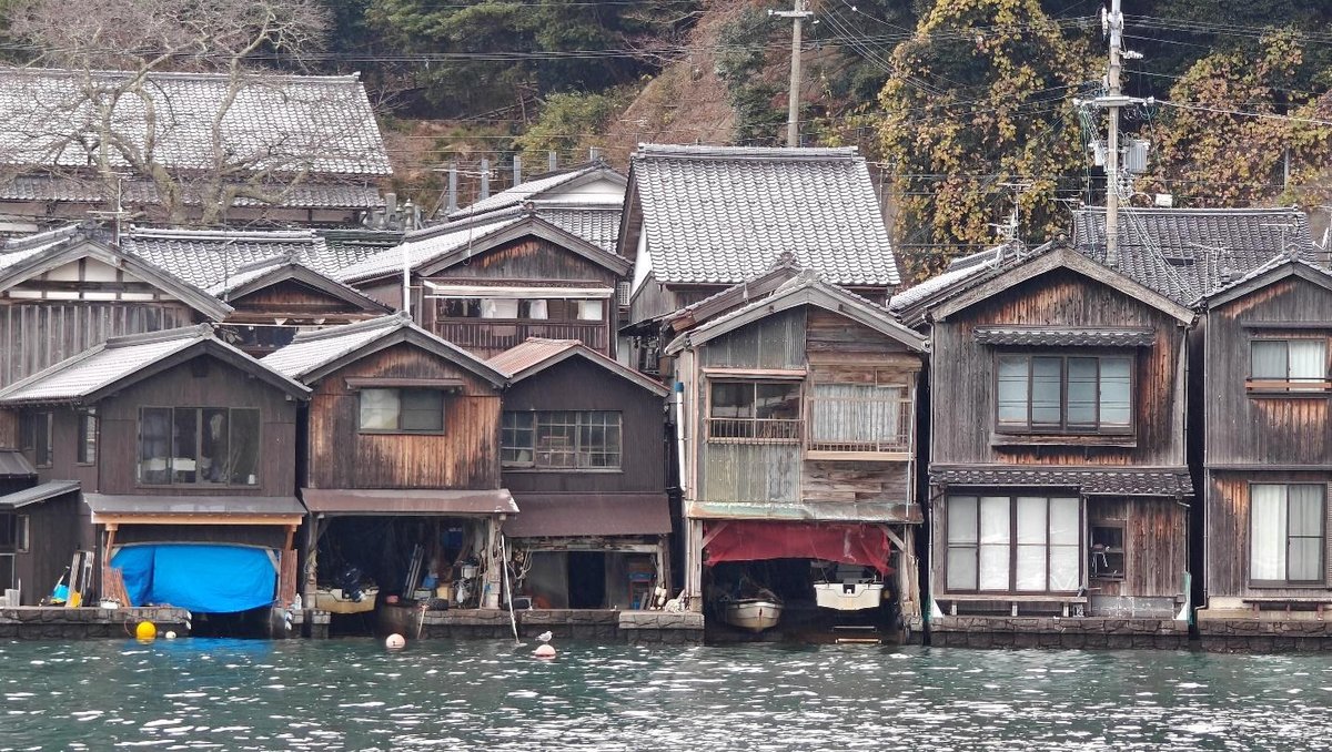 Traditional wooden boathouses by a serene waterfront
