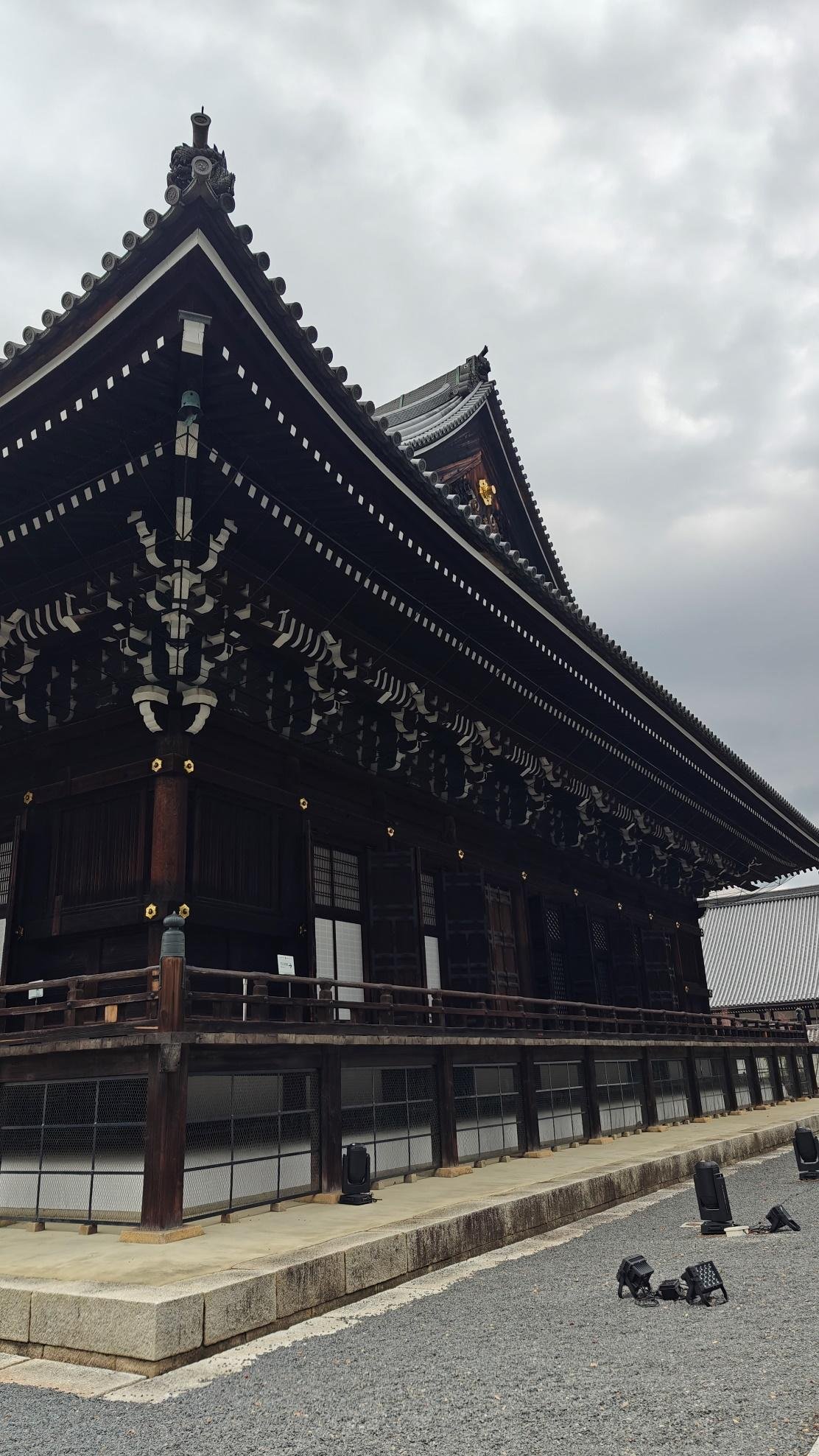 Traditional wooden temple under cloudy sky
