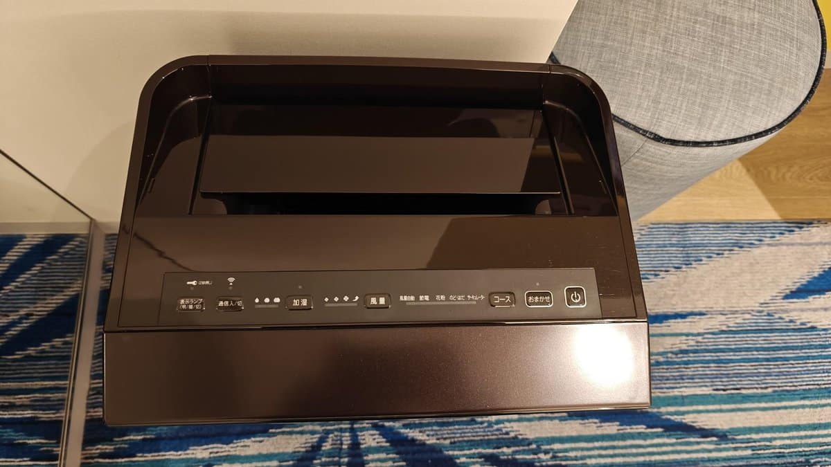 Black humidifier on blue carpet