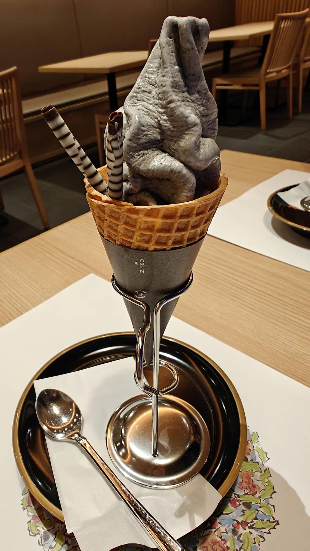 Black ice cream cone with chocolate sticks