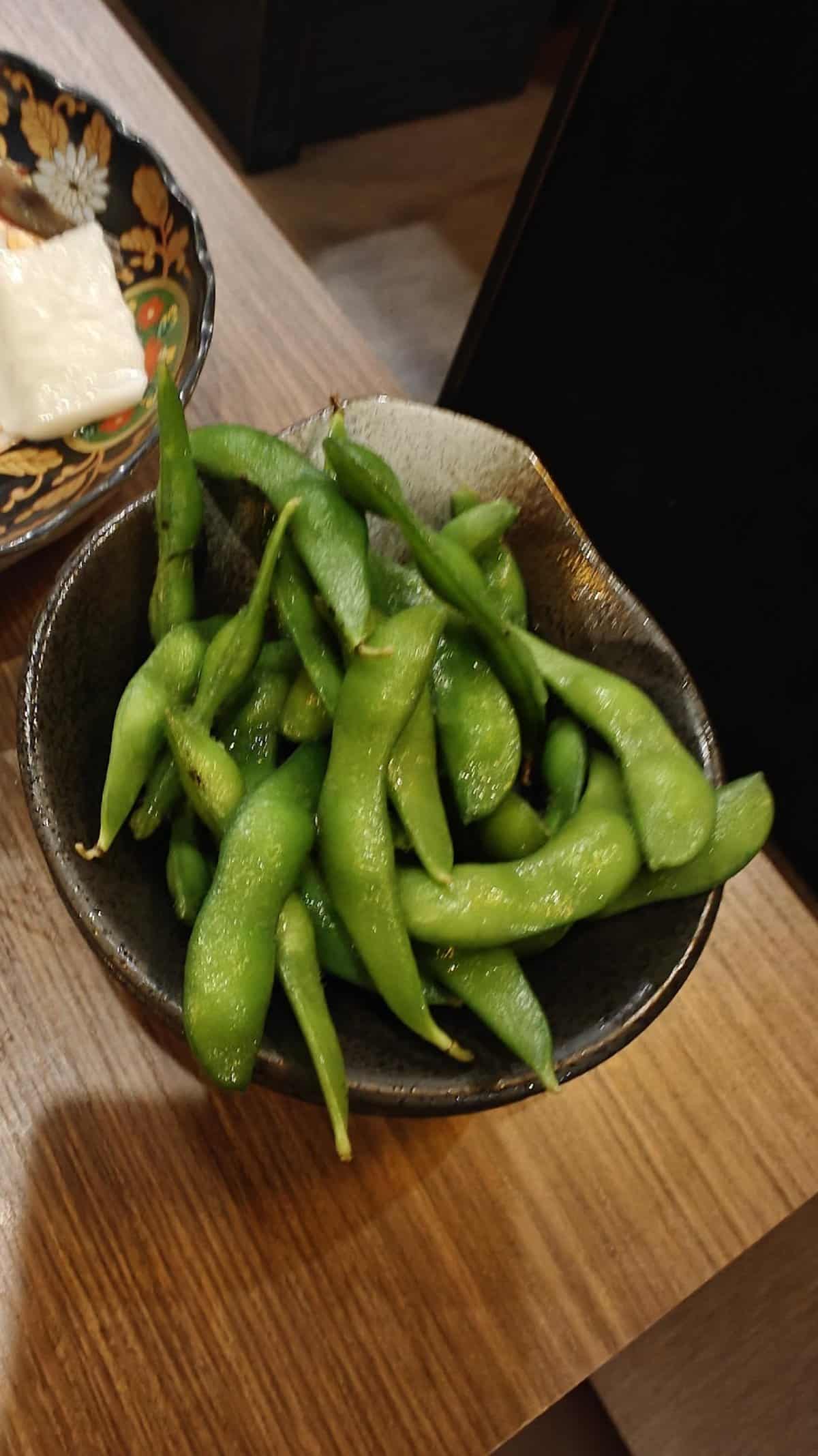 Bowl of edamame beans on table