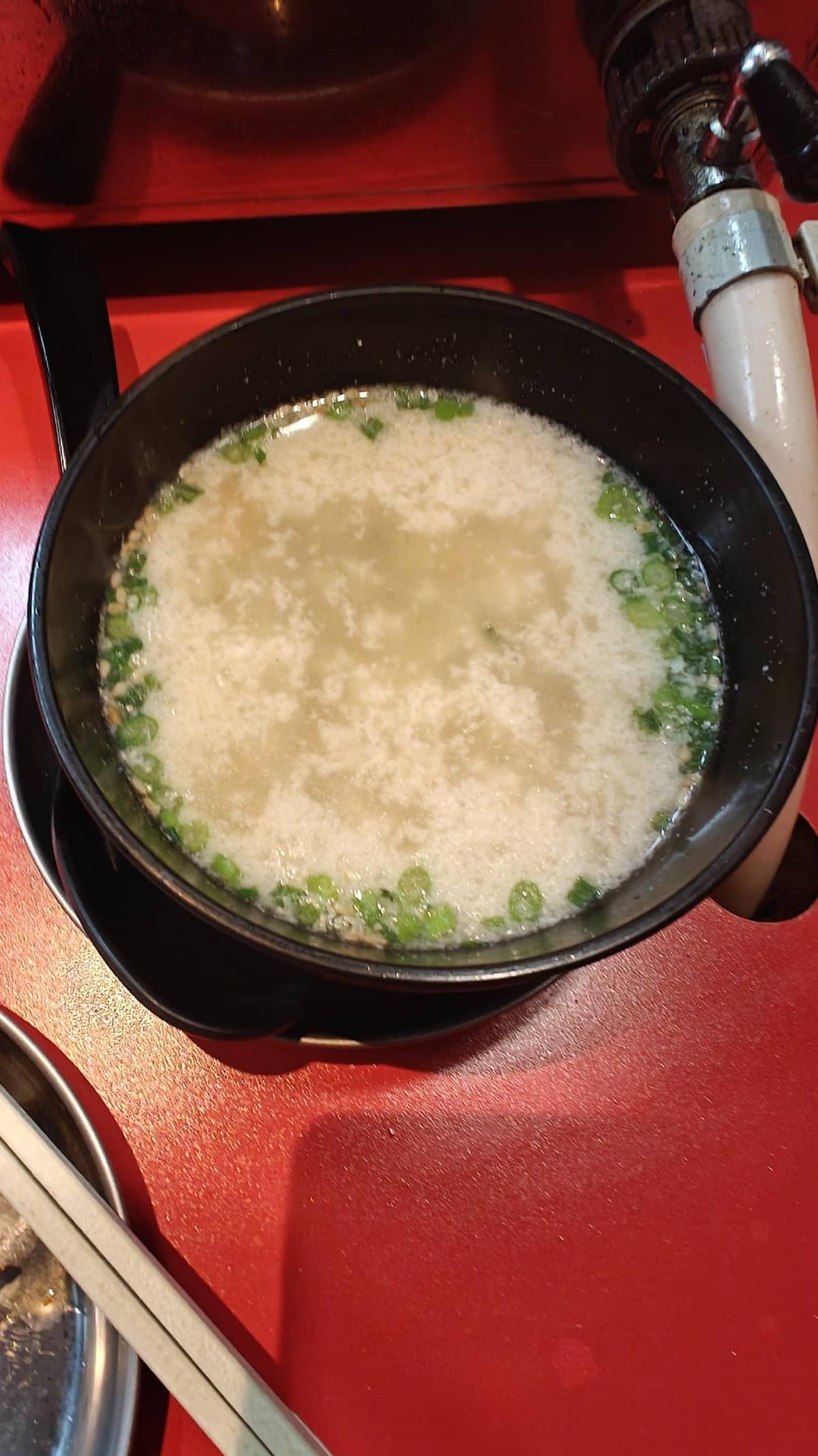 Bowl of miso soup with green onions