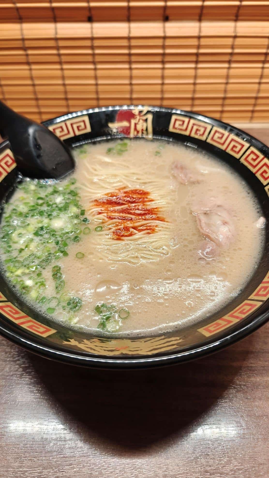Bowl of ramen with scallions and chili