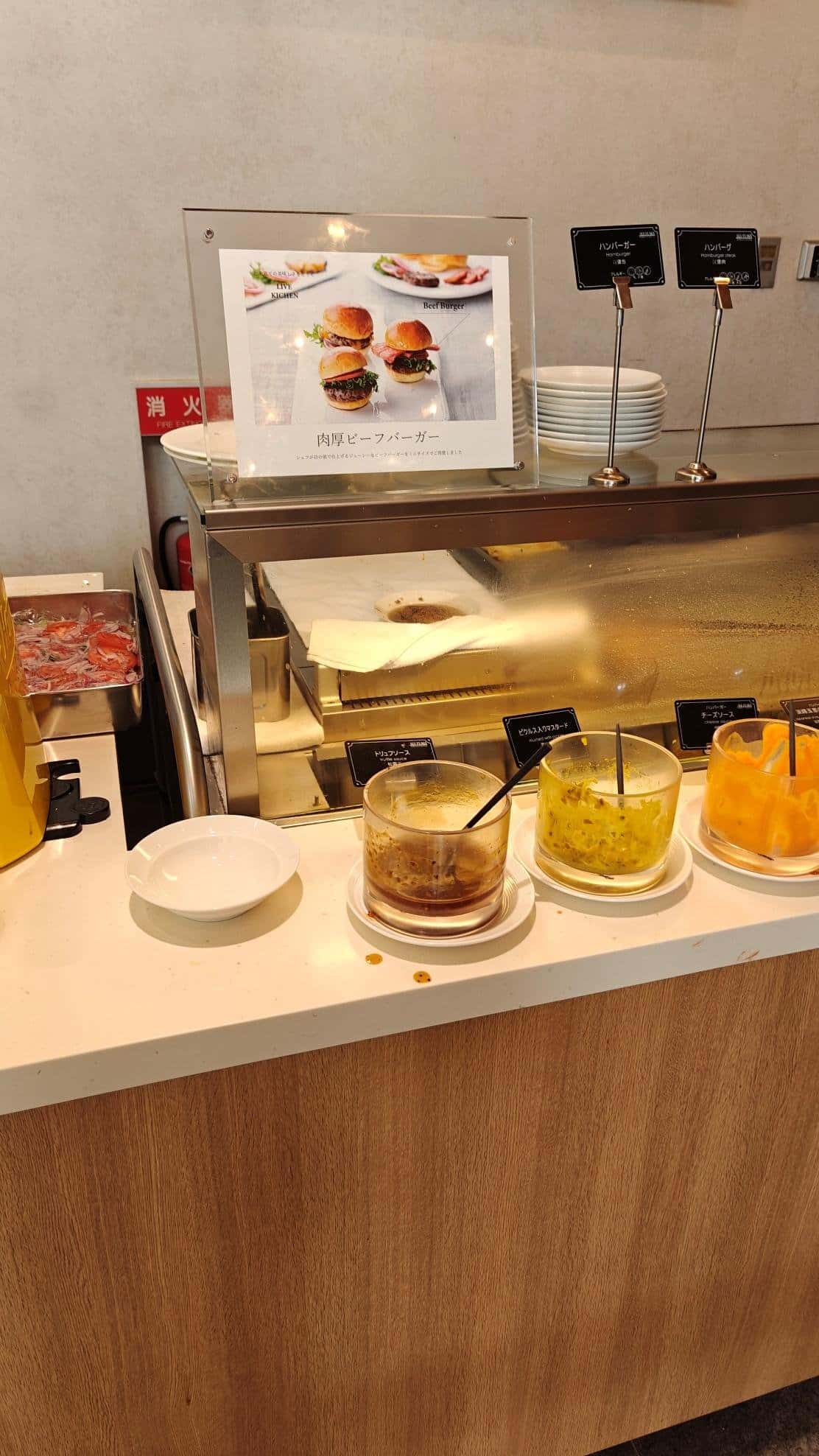 Buffet condiments and sign for burgers