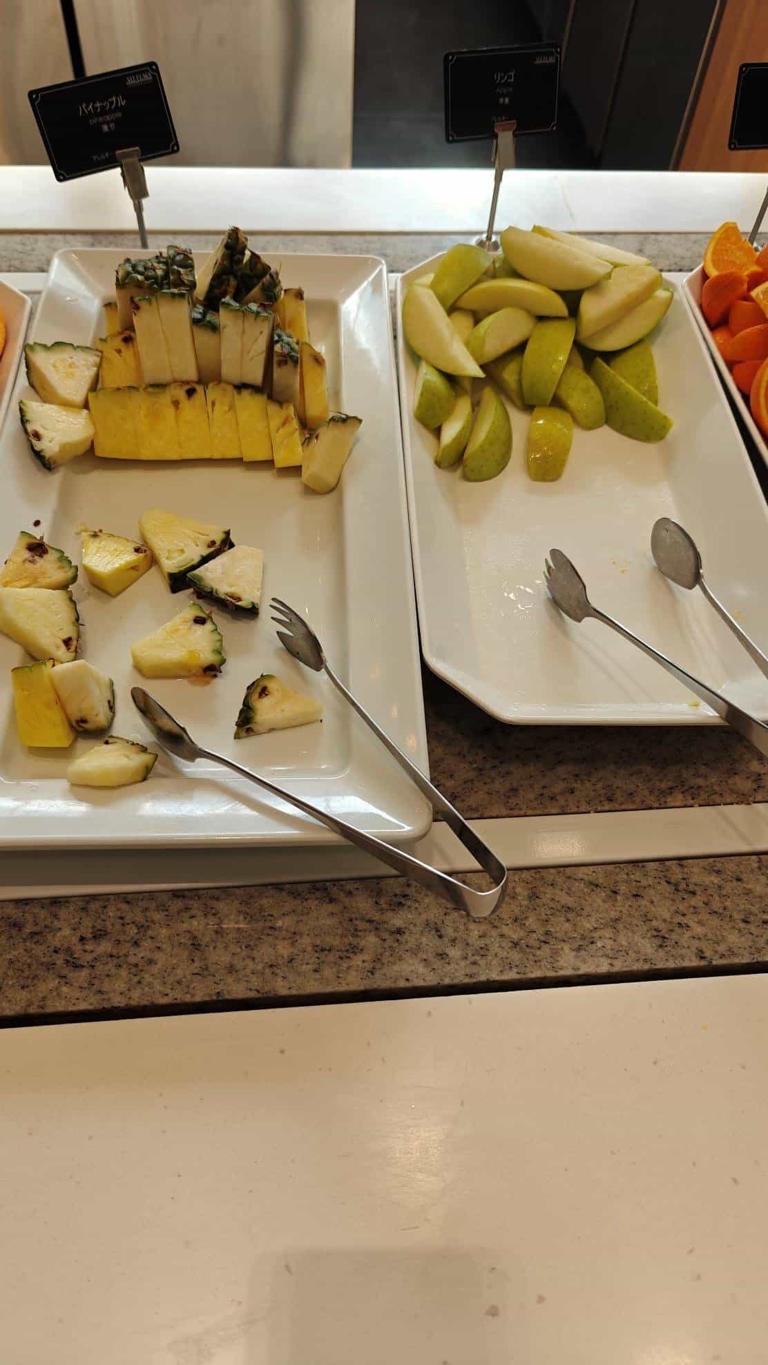 Buffet with sliced pineapple and pears