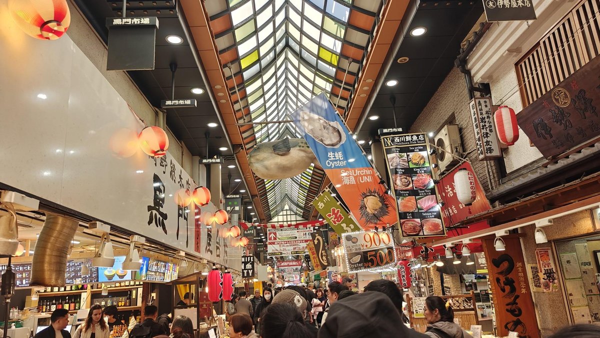 Bustling indoor market with colorful signs