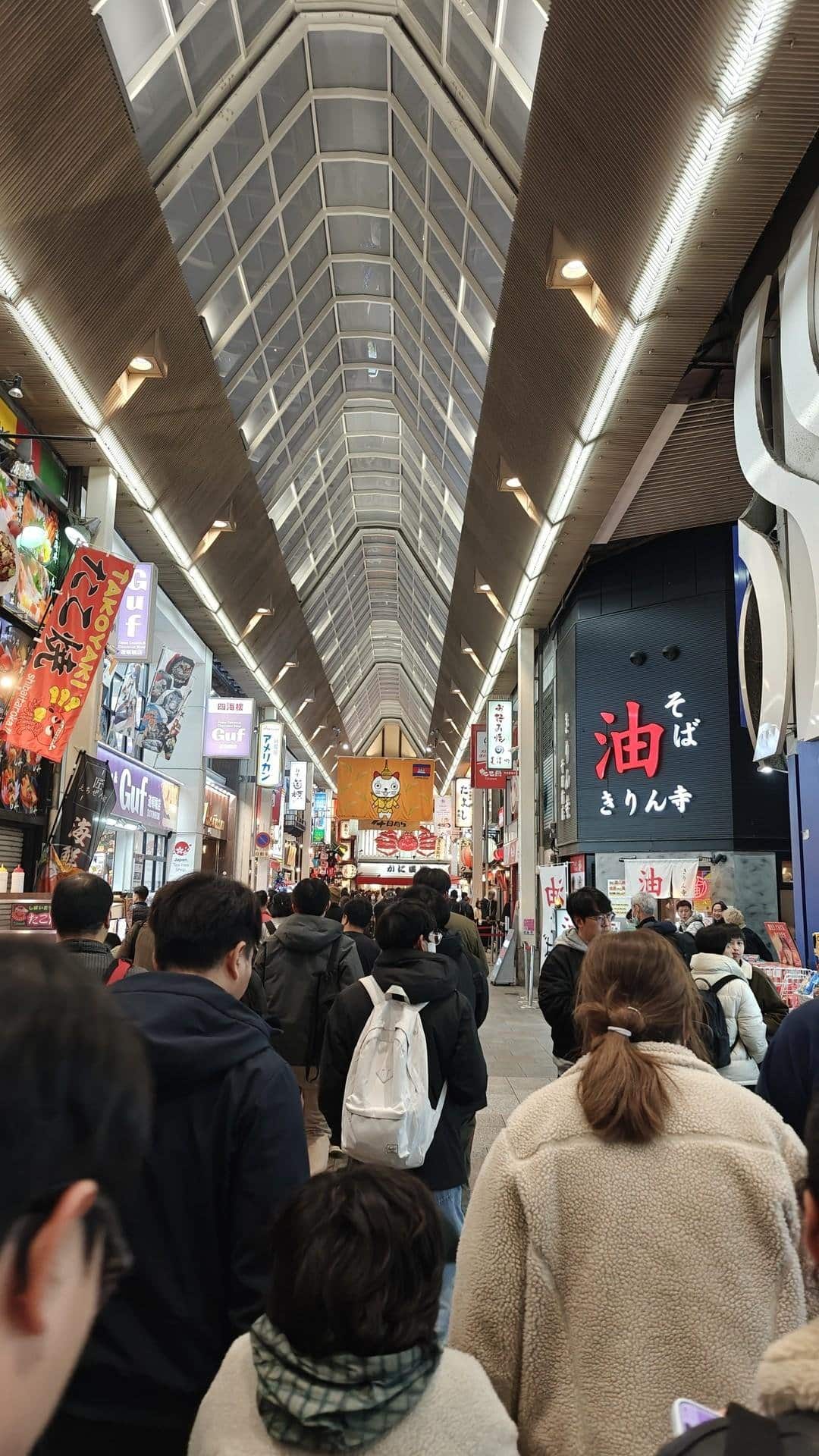 Bustling indoor street with signs