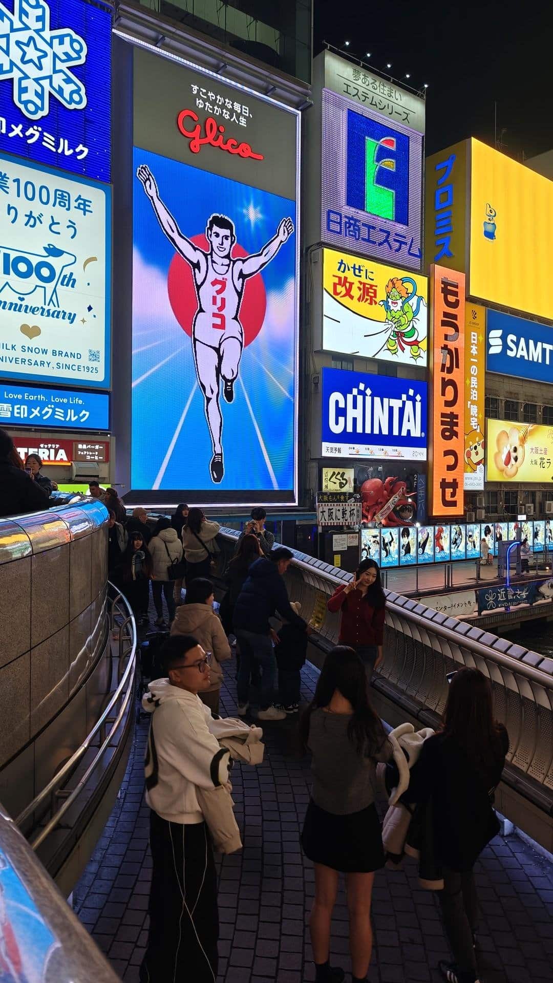 Busy neon-lit street at night
