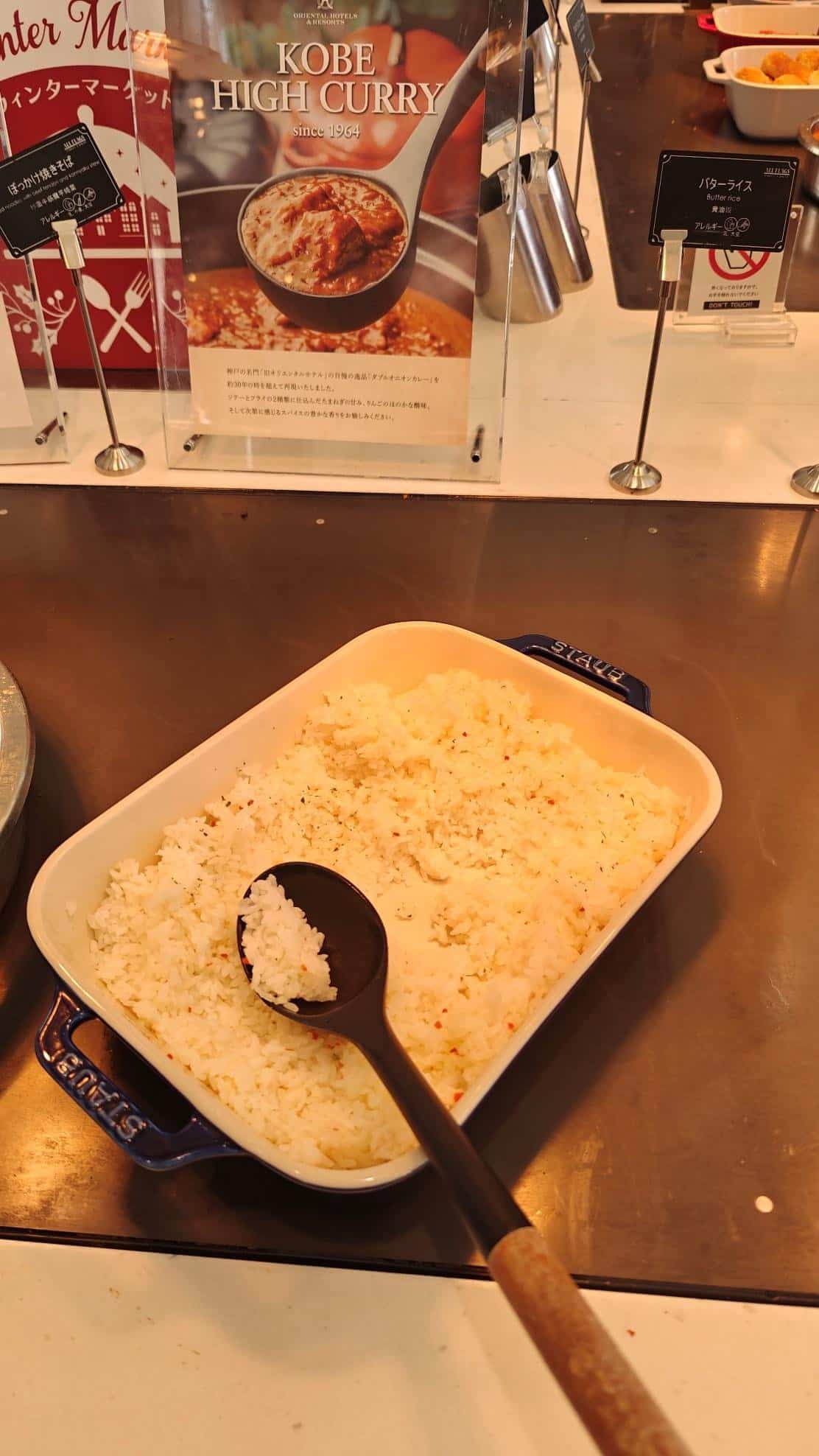 Butter rice in serving dish with ladle