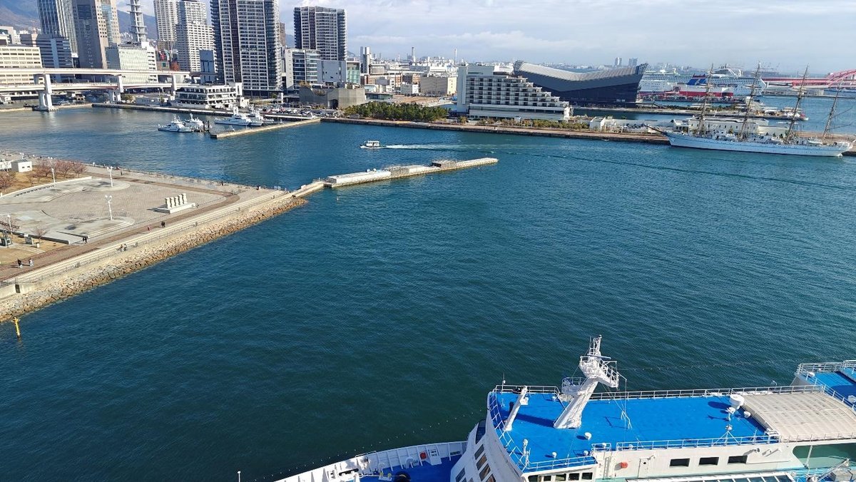 Coastal cityscape with ships and skyline