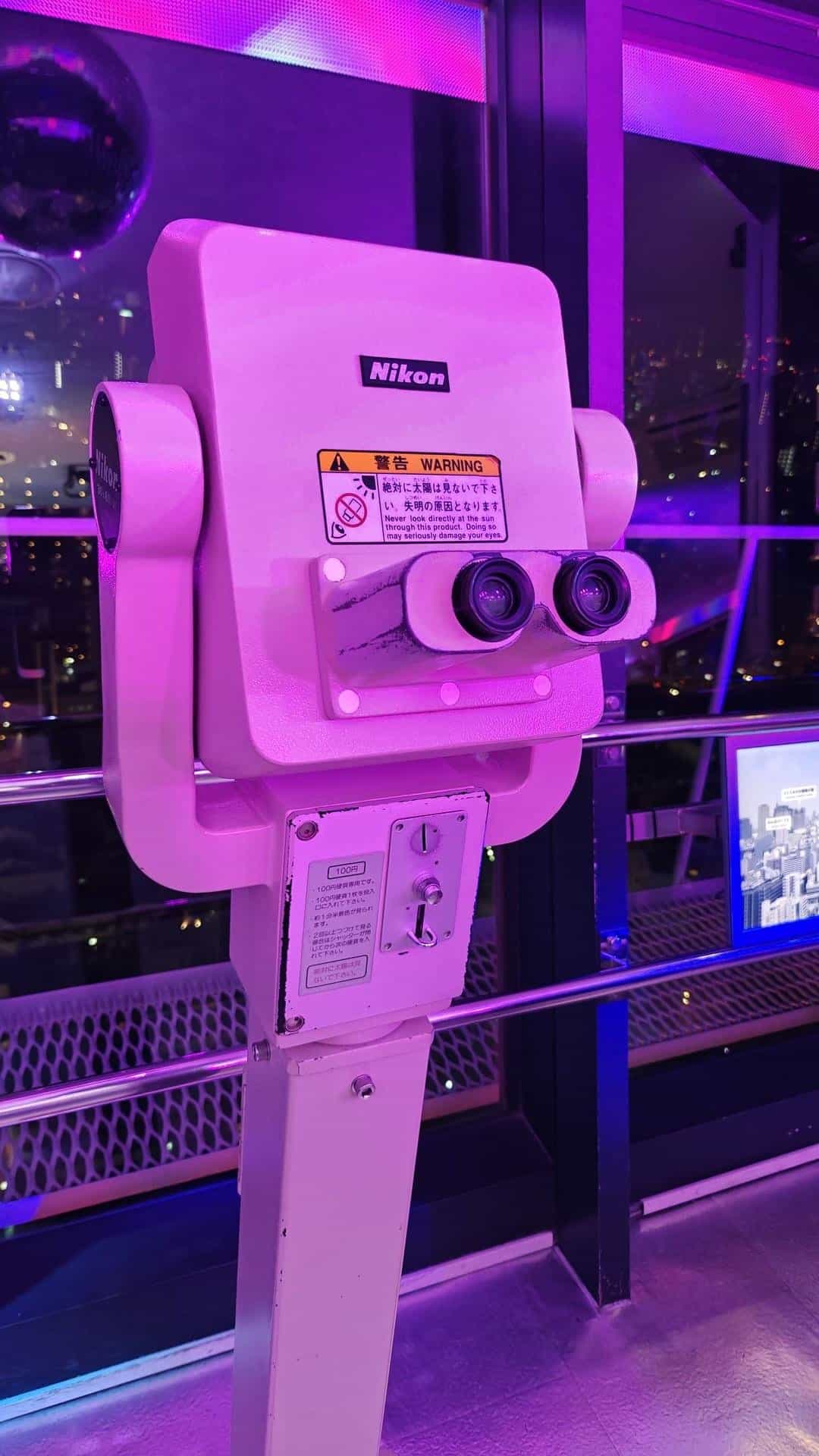 Coin-operated binoculars with purple glow